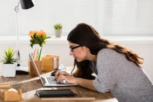 woman with bad posture over computer